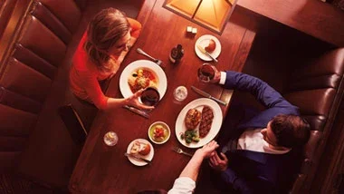 Overhead view of a couple dining, featured on Ameristar Council Bluffs’ dining page.