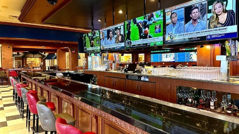 Amerisports bar with multiple televisions behind the bar at Ameristar Council Bluffs.