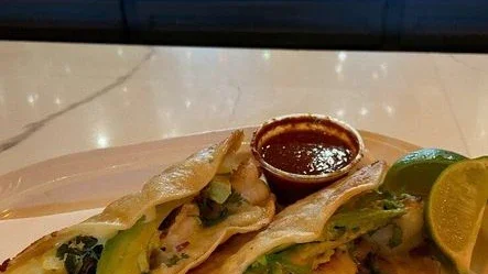 Bankers Casino Salinas 2 Two tacos served with salsa and lime wedges at the Bankers Casino bar.