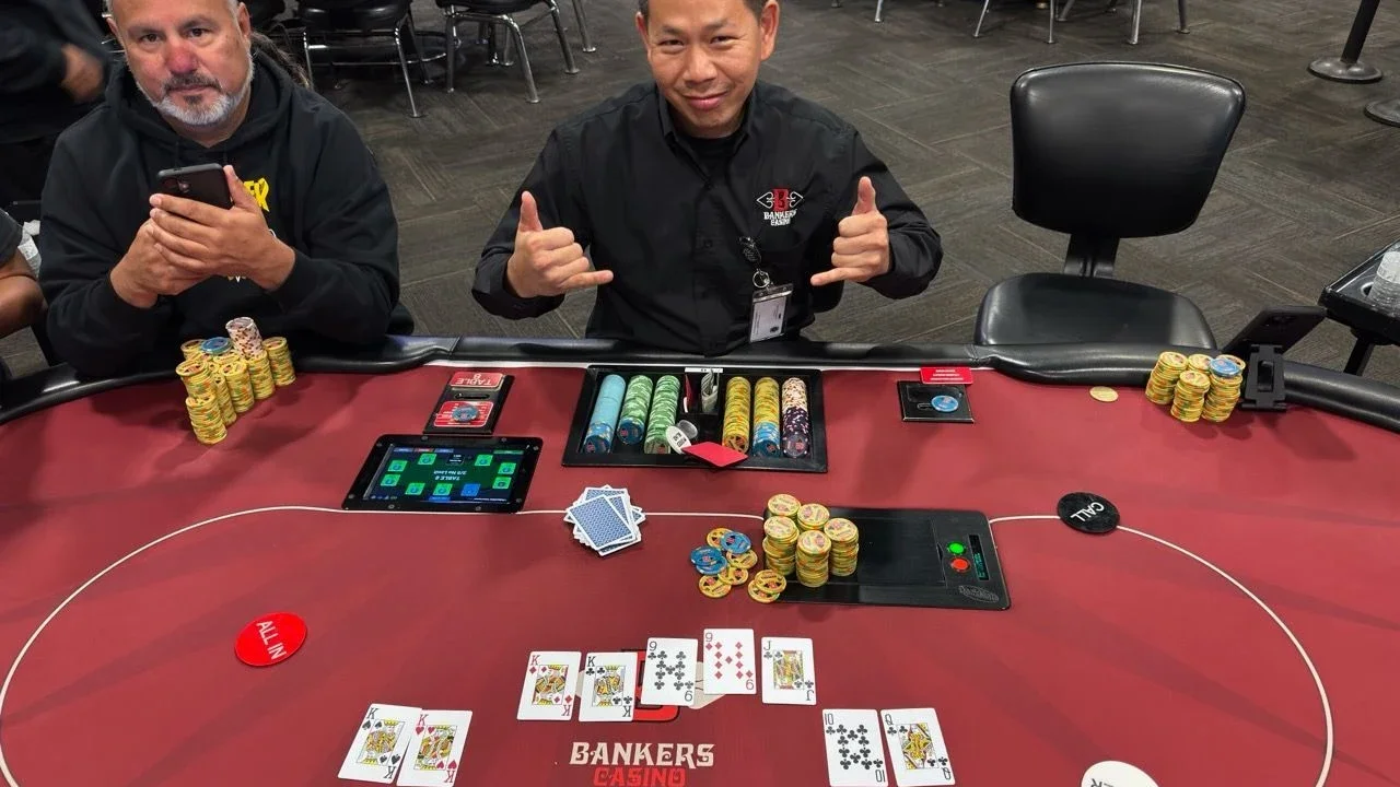 Bankers Casino Salinas 4 Two people seated at a Bankers Casino poker table with chips and cards.