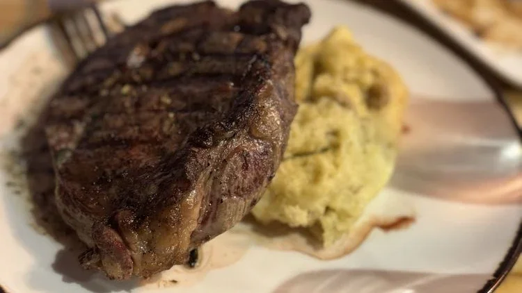 Customer photo of medium-rare rib eye with potatoes and green beans at Louie Oliver's Restaurant & Bar at Harrah's Northern California.