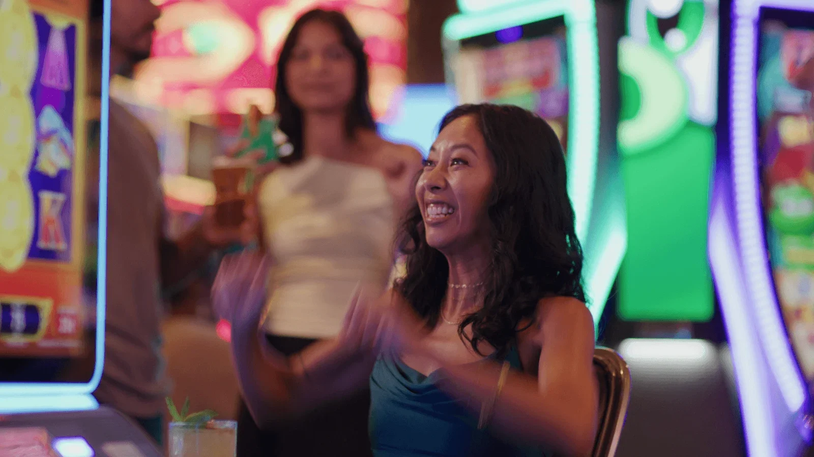 Two women celebrating a slot machine win at Jamul Casino Resort.