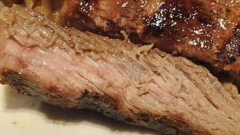 Customer close-up photo of a ribeye end tip at Center Stage Bar and Grill; the customer described it as well-done despite requesting medium rare.